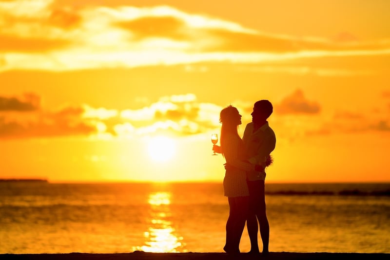 Couple at the sea during sunset